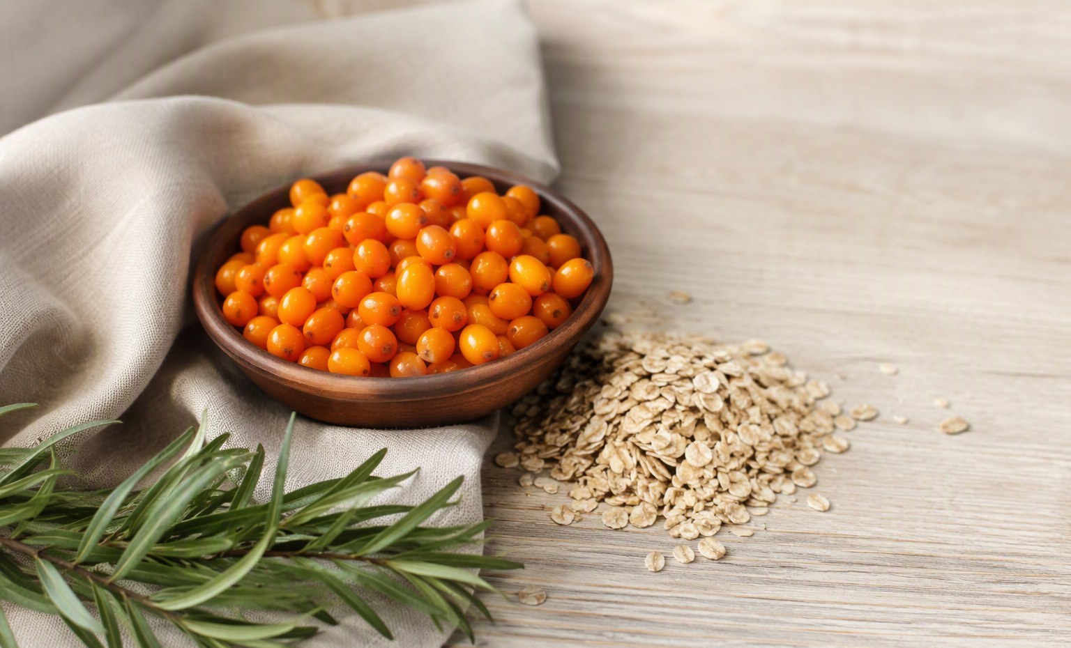 A bowl of sea buckthorn berries with oats, foods studied for cholesterol