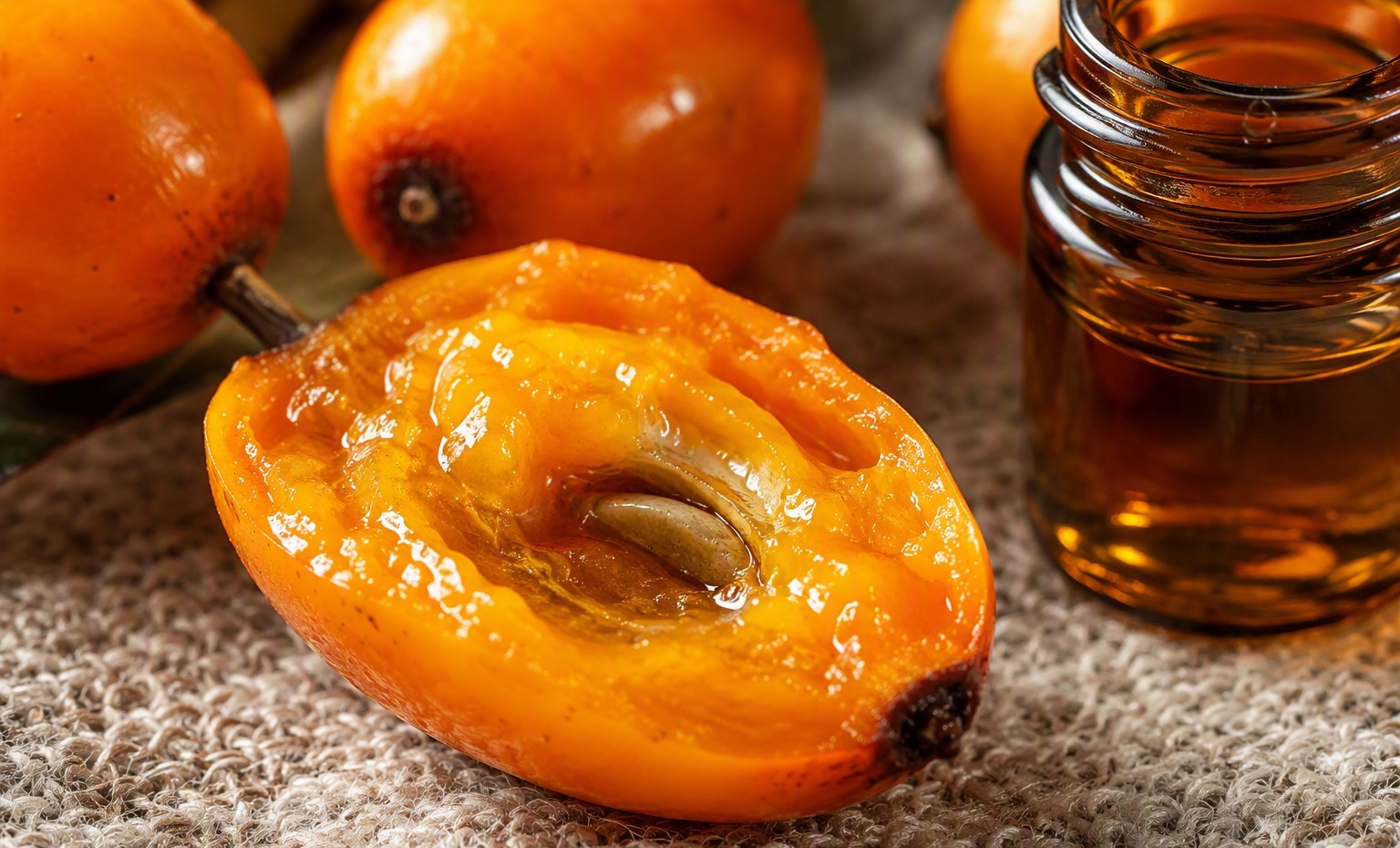 A sea buckthorn berry split open, its omega-7-rich orange pulp glistening
